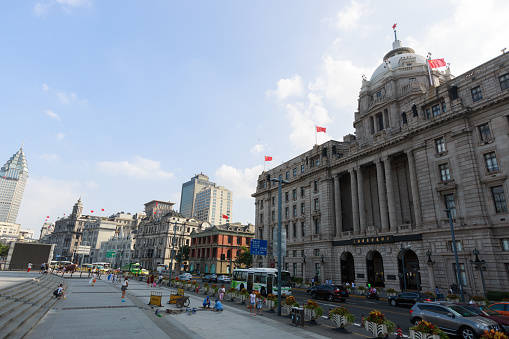 Shanghai, China - August 6, 2015: People walk past the waterfront at the Bund in Shanghai, China. It is one of the most famous tourist destinations in Shanghai.