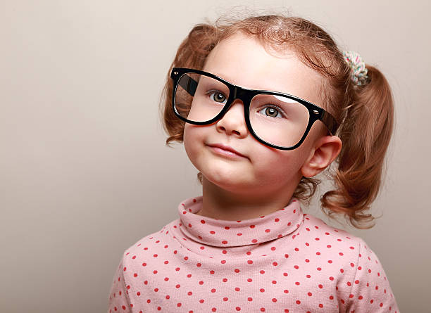istock Dreaming cute girl in glasses looking up on copy space 484012125