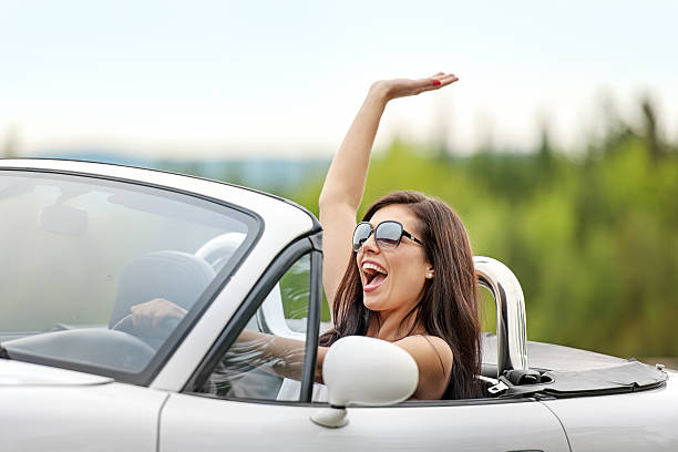 istock Woman in a cabriolet 484012203