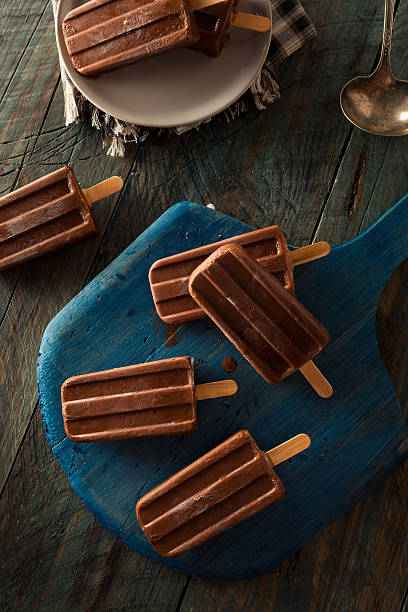 Homemade Cold Chocolate Fudge Popsicles Homemade Cold Chocolate Fudge Popsicles on a Stick fudge stock pictures, royalty-free photos & images