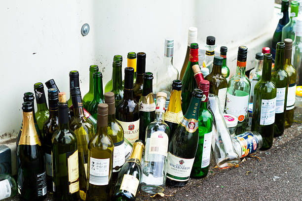 Many empty vine and sparkling wine bottles Many empty vien and sparkling wine bottles at container for collecting used glasses and bottles in Germany. Non editorial shot with many logos. heidelberg germany photos stock pictures, royalty-free photos & images