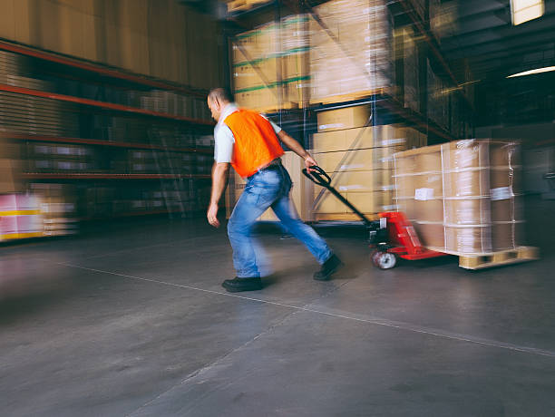 istock worker with hand pallet truck 484013919