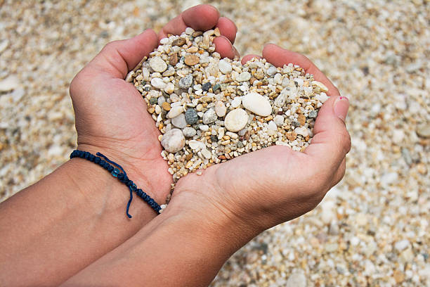 istock Heart shape made of pebbles in female hands 484015146