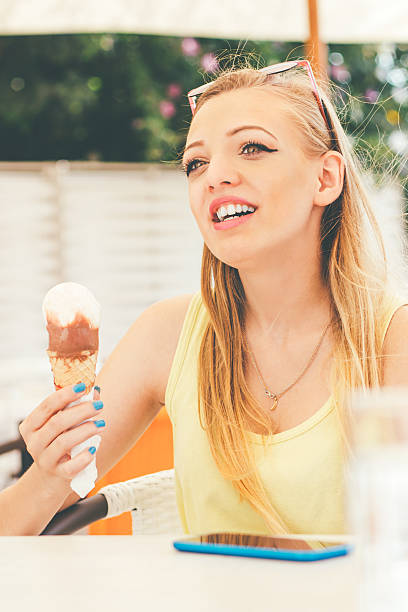 istock Young girl in the cafe with a ice cream 484017734