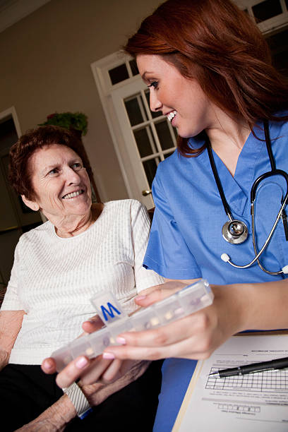 istock Healthcare Worker Giving Medication Instructions to Elderly Patient 484018731