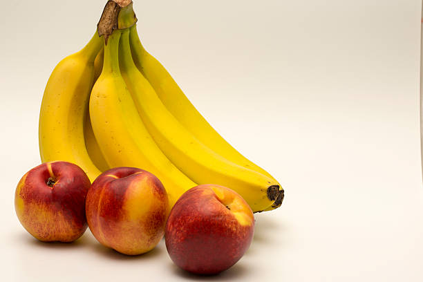 istock bananas and nectarines isolated on white 484018815