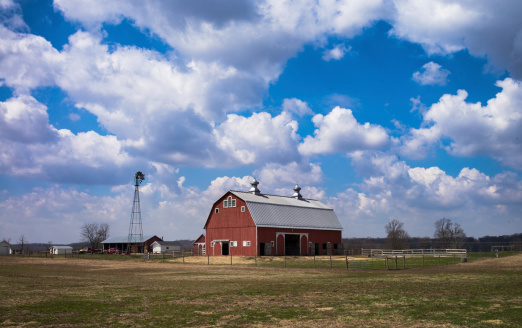 A red barn and windmill on the Indiana prairie.