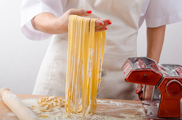 istock Young woman chef prepares homemade pasta 484019528