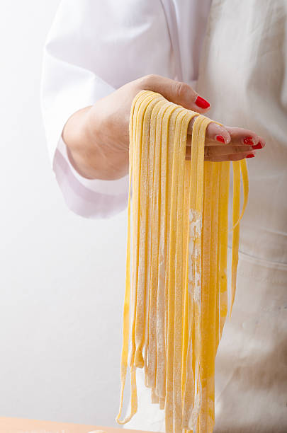 istock Young woman chef prepares homemade pasta 484019536