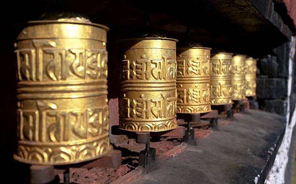 golden budista ruedas de oración - tibetan script fotografías e imágenes de stock