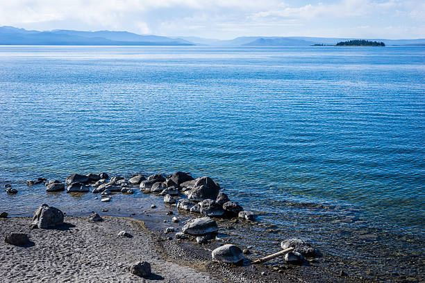Yellowstone Lake with island and blue sky stock photo