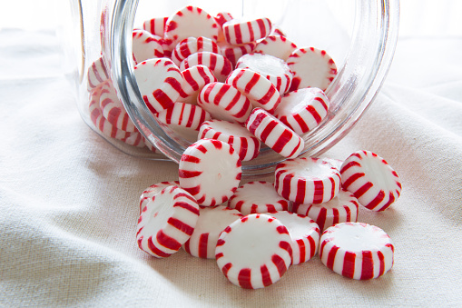 Lots of Peppermint Candy spilling out of a Jar