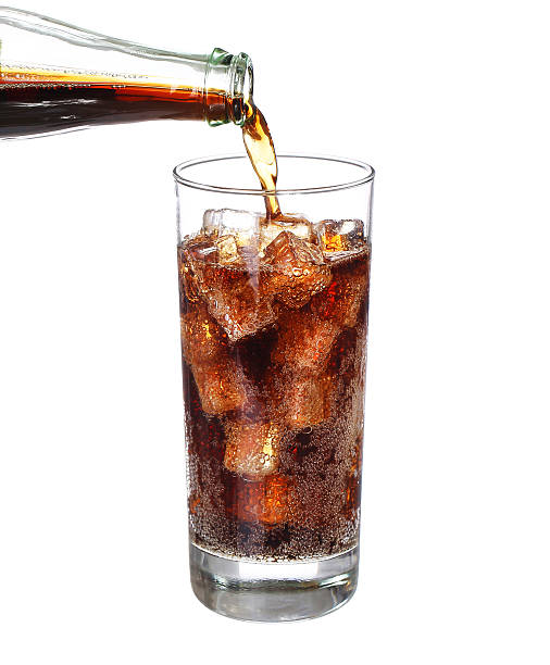 istock bottle pouring coke in drink glass with ice cubes Isolated 484025986