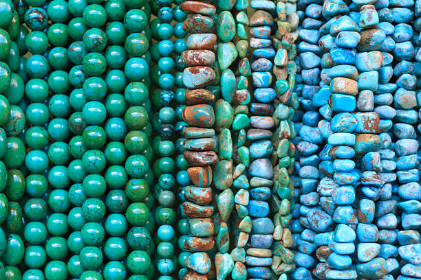 istock Bright Turquoise and Green Beads Hanging in Shop (Close-Up) 484026130
