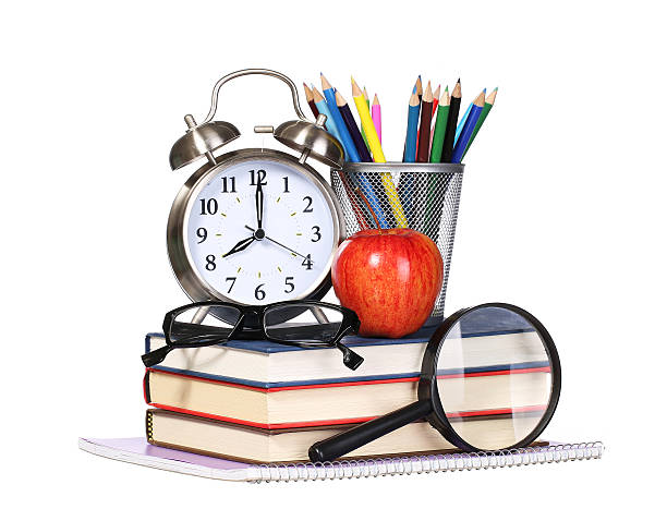 istock Books, apple, alarm clock and pencils isolated on white 484026832