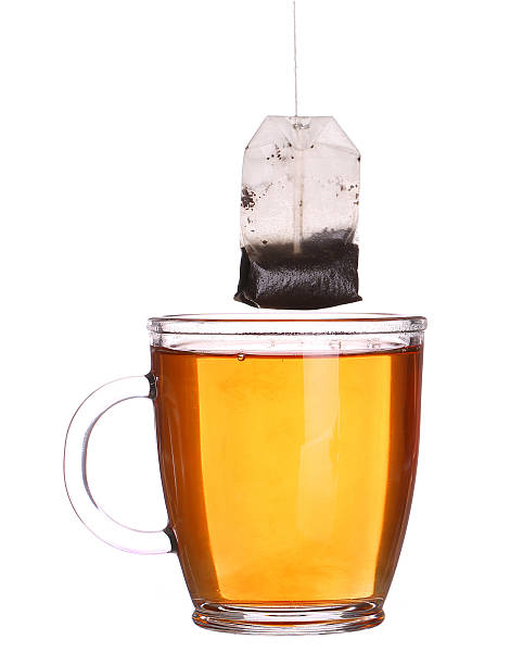 istock glass cup of tea with tea bag isolated on white 484029266