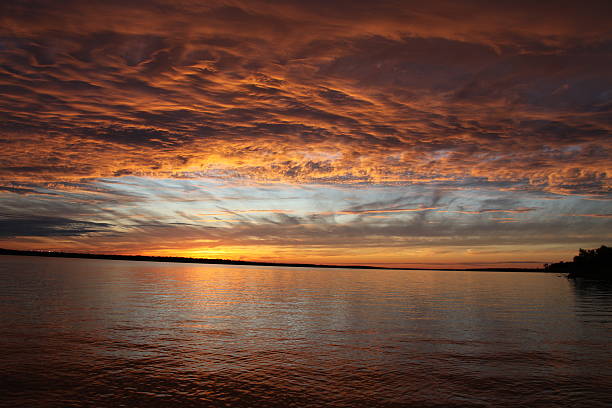 This is a fiery orange sunset setting over Grapevine Lake.