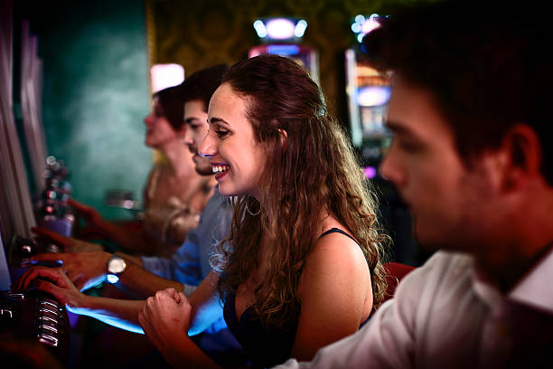 istock Friends gambling on slot machines 484031141