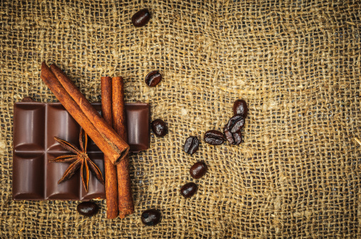 Composition with coffee beans, spice, cinnamon, star anise and bar of chocolate