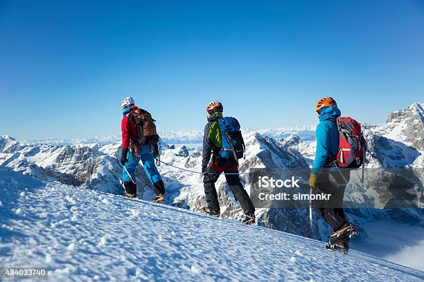 Men Hiking On Snow Covered Landscape Stock Photo - Download Image Now - Snow, Backpack, Side View