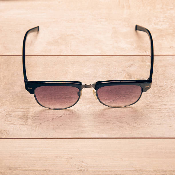 istock black sunglasses on wood floor 484033758