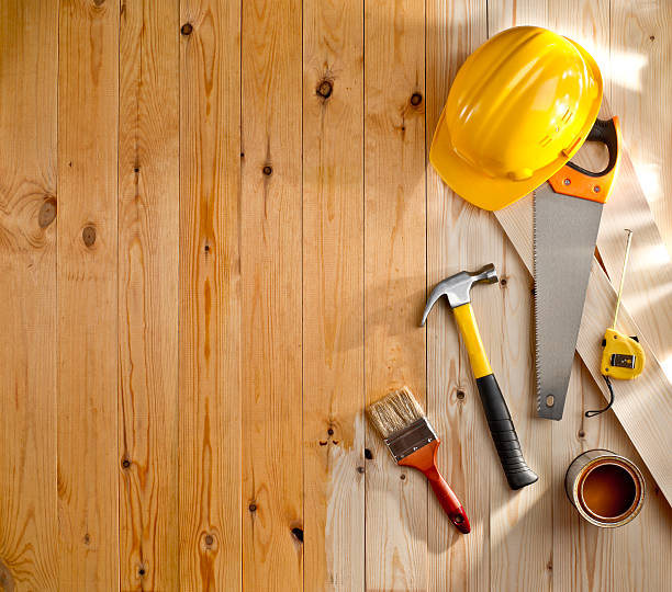 istock wood floor with a brush, paint, tools and helmet 484034025