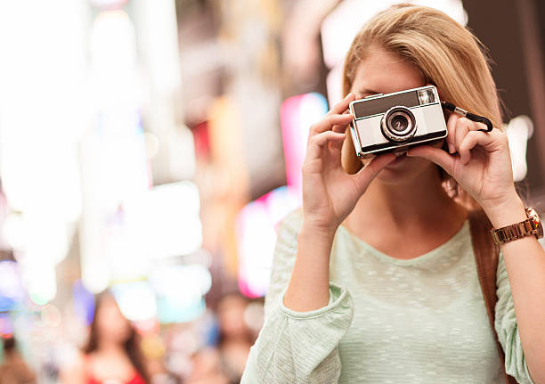 istock tourist take a picture in times square - NYC 484034117