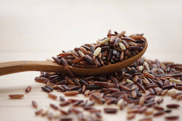 istock brown rice and wooden spoon 484034184