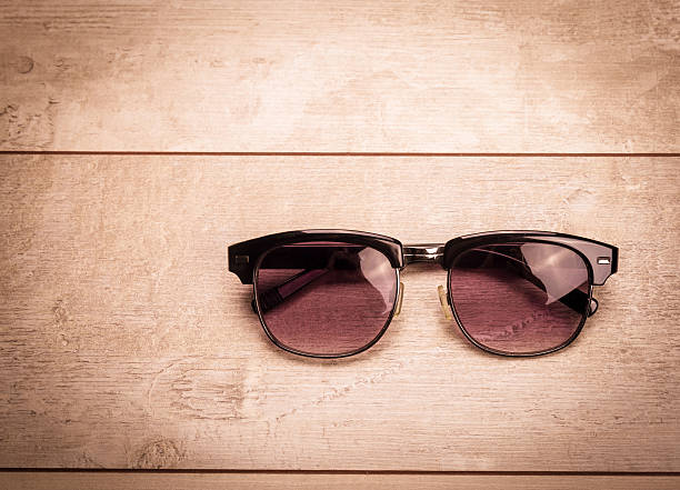 istock black sunglasses on wood floor 484034728