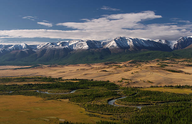 istock Asian snow-capped mountains in the background River meanders 484035190