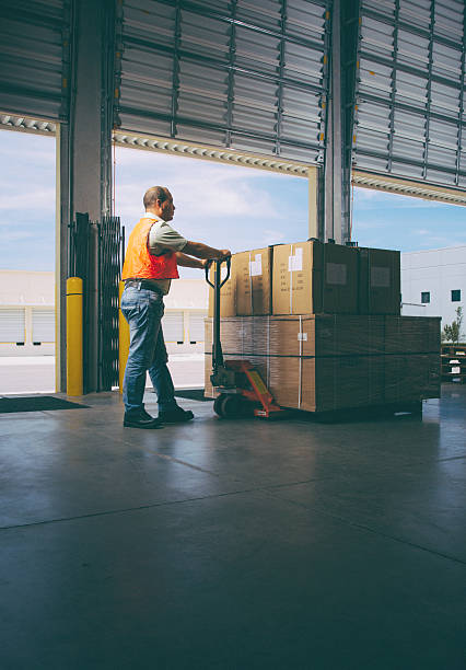 istock worker with hand pallet truck 484036457