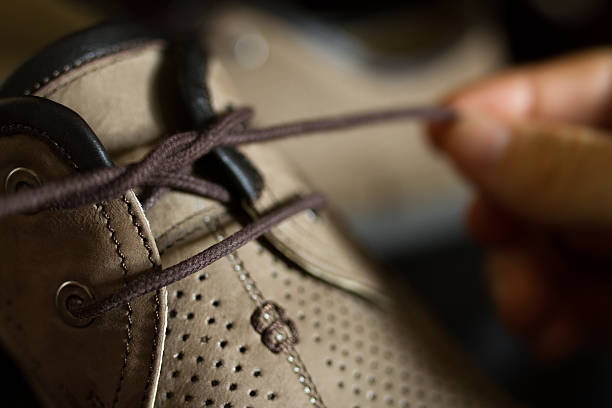 istock Lacing men's summer shoes on black background 484037964