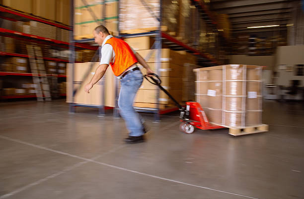 istock worker with hand pallet truck 484038315
