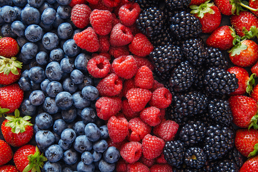 Healthy mixed fruit and ingredients with strawberry, raspberry, blueberry, blackberry from top view