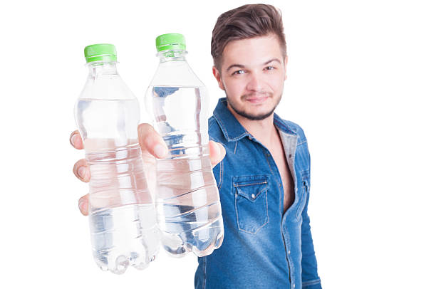 istock Handsome male model offering two bottles of cold water 484041316