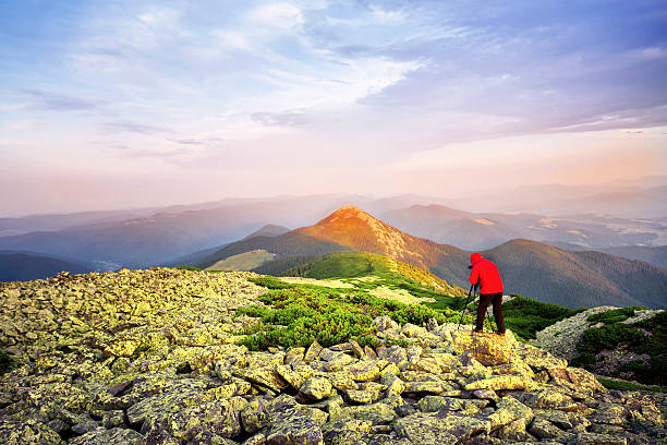 istock Photographer taking pictures on a hill mountaintop 484041506