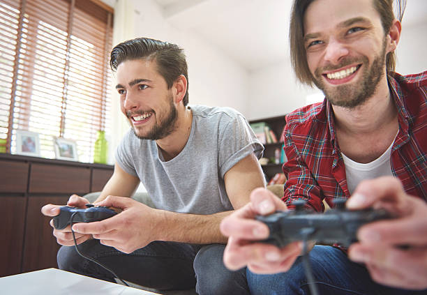 istock Rivalry  between friends in front of TV 484041668