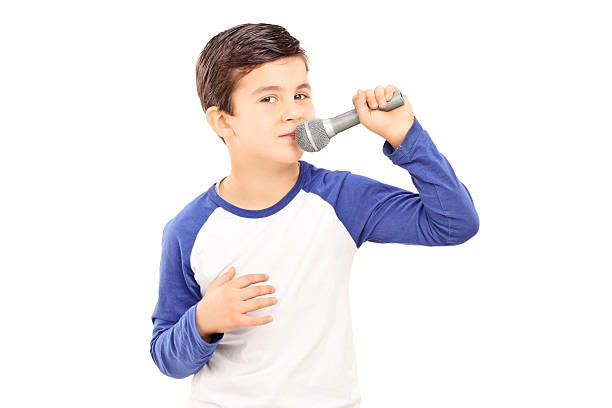 istock Joyful little kid singing on a microphone 484042054