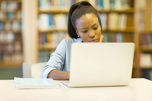 istock female afro american university student using laptop 484042524