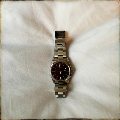 Pittsburgh, USA - August 8, 2018  Ladies Rolex Oyster Perpetual Air King watch on a fabric background.   Photographed with an iPhone and Hipstamatic.