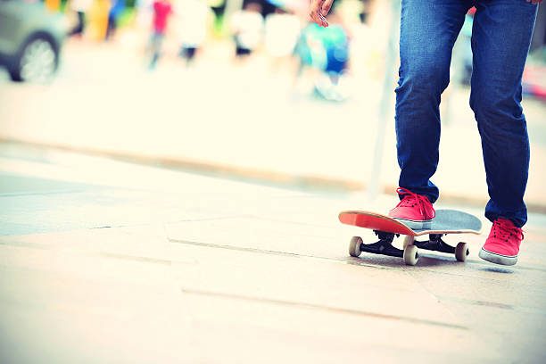 istock young skateboarder legs riding on skateboard on city 484043684