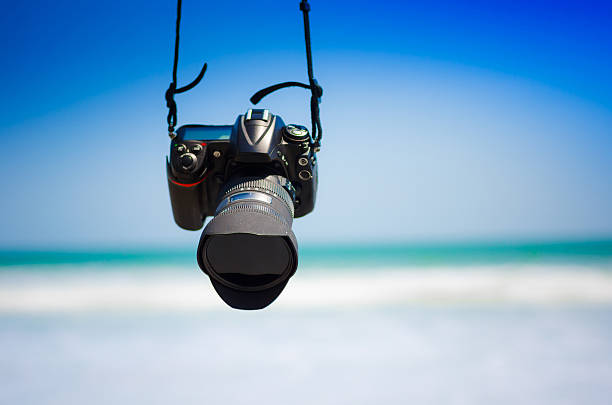 istock DSLR camera hanging at  the beach scenery 484044086