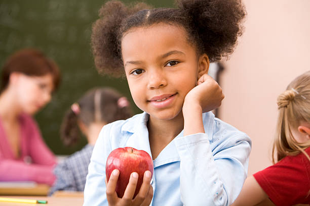 istock Girl with red apple 484045298