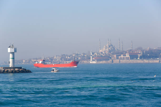 istanbul, turkey - March 15, 2014: Industrial ship and fisherman boat are passing bosphorus strait at istanbul turkey
