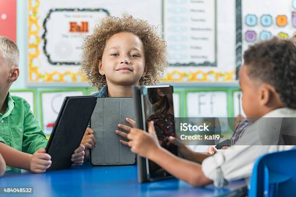 Multiracial Children In Kindergarten With Digital Tablet Stock Photo - Download Image Now