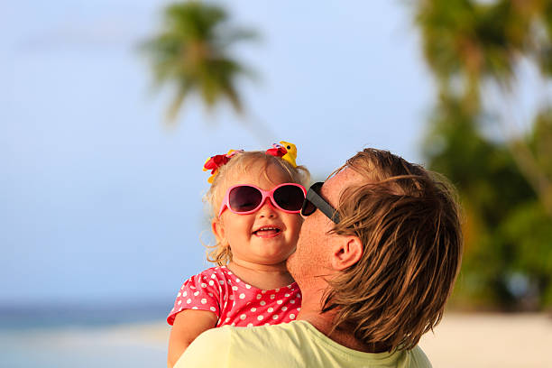 istock Happy father and cute little daughter at beach 484056514