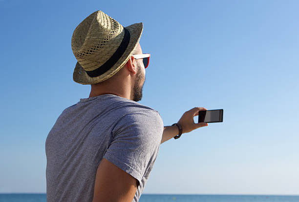 istock Young man taking selfie by the sea 484057290
