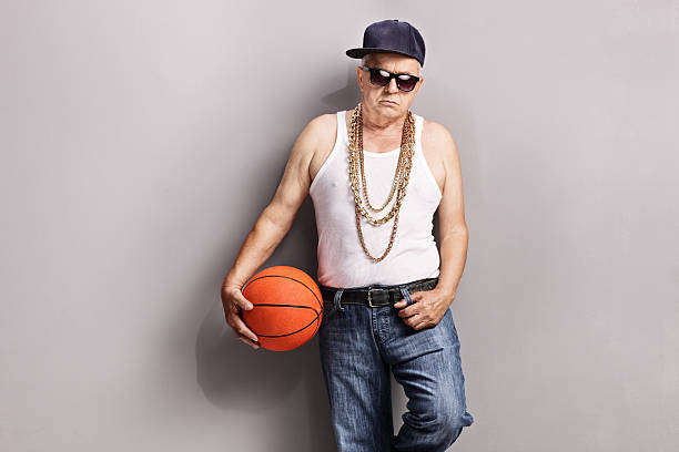 istock Grumpy senior in a hip-hop outfit holding a basketball 484058272