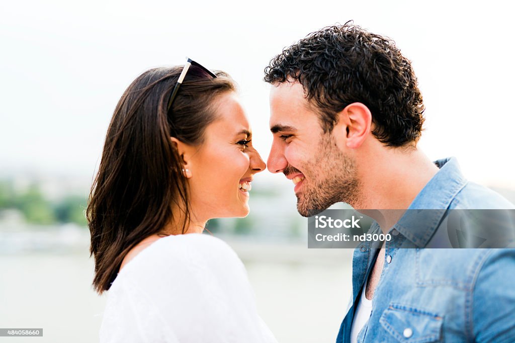 Young beautiful couple rubbing noses as a sign of love Young beautiful couple rubbing noses as a sign of love and about to kiss each other Kissing Stock Photo