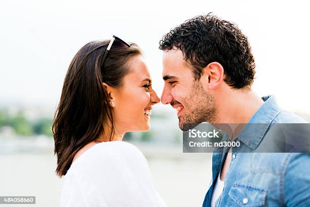 Young Beautiful Couple Rubbing Noses As A Sign Of Love Stock Photo - Download Image Now